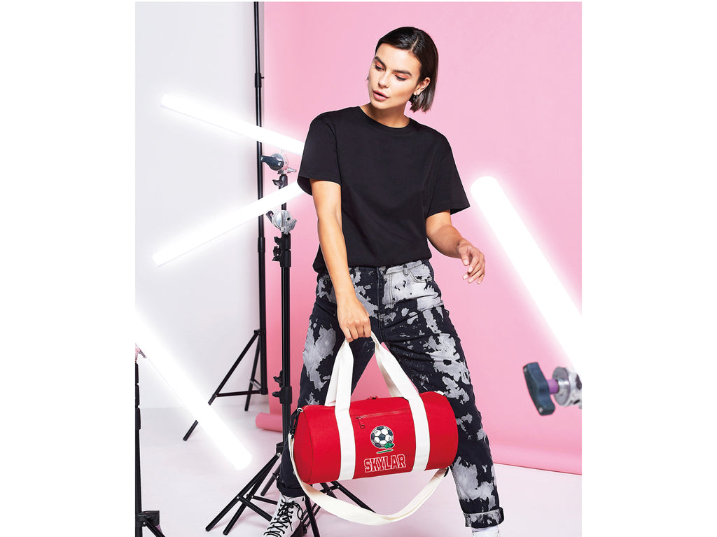 Lady carrying red personalised football kit bag