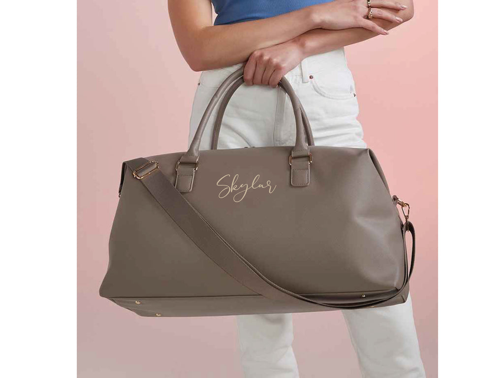 Personalised name weekend holdall bag in taupe. Made from Vegan leather