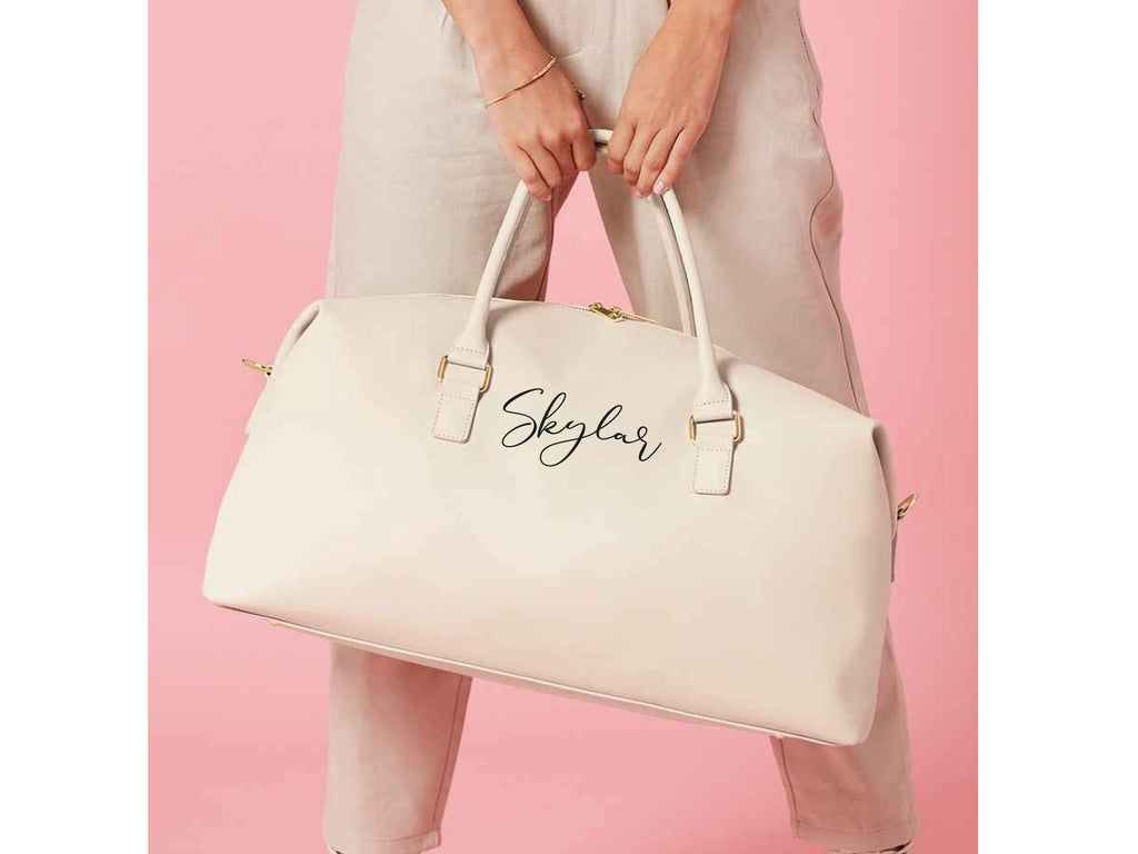 Personalised name weekend holdall bag in oyster. Made from Vegan leather