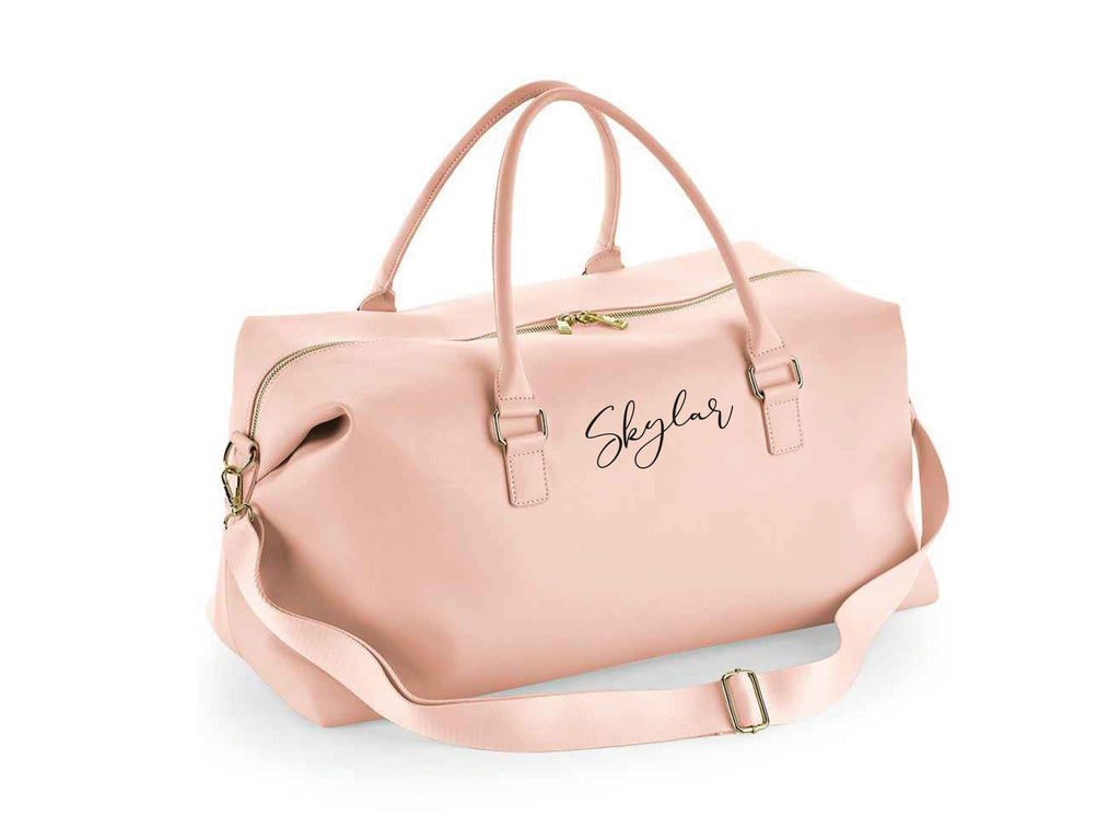 Personalised name weekend holdall bag in pink. Made from Vegan leather